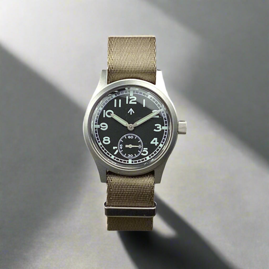 Aeschbach x Enoksen 'Fly' E03/T Dirty Dozen Automatic watch, 36mm, black dial, shown with a Khaki Seatbelt NATO strap.